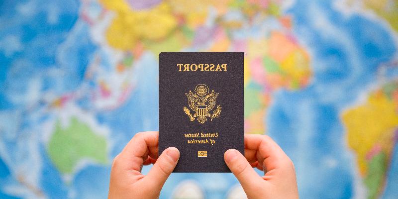 student holding passport image